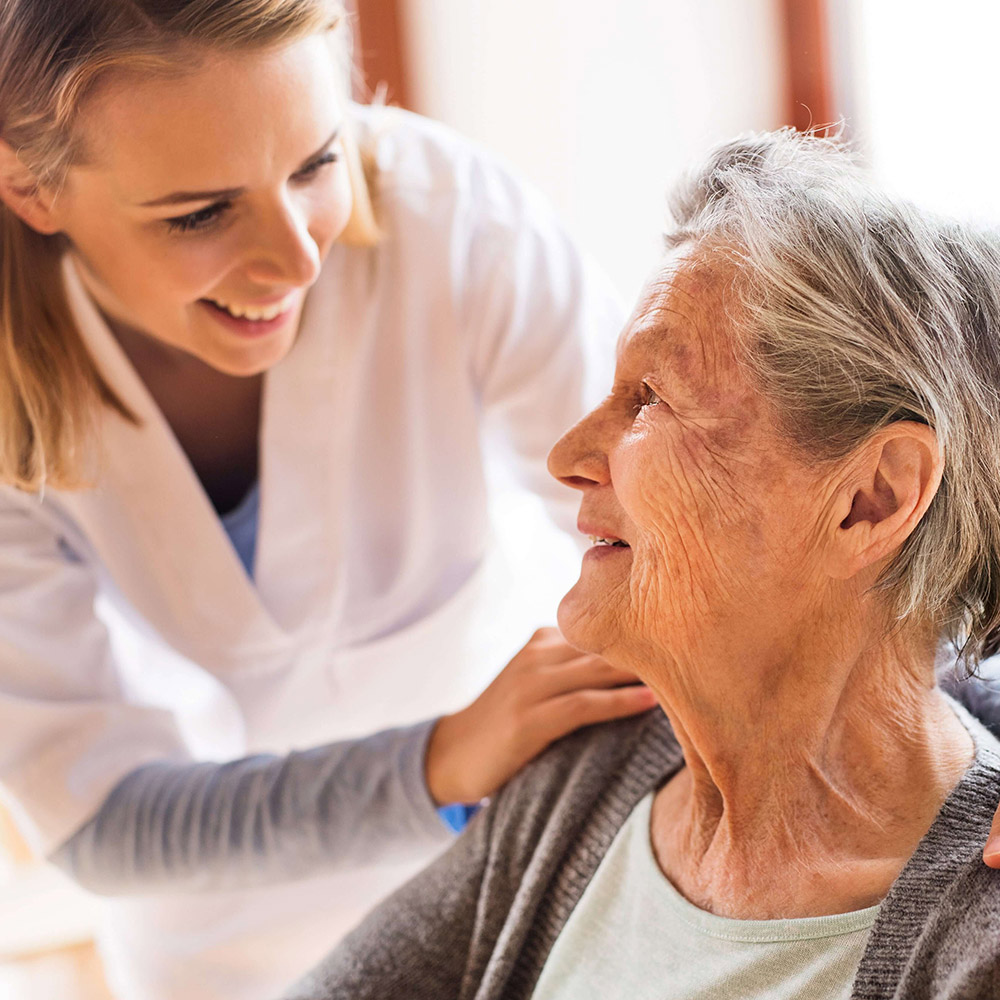 shutterstock_735361786-min (1) Smiling Elderly Woman and Caretaker